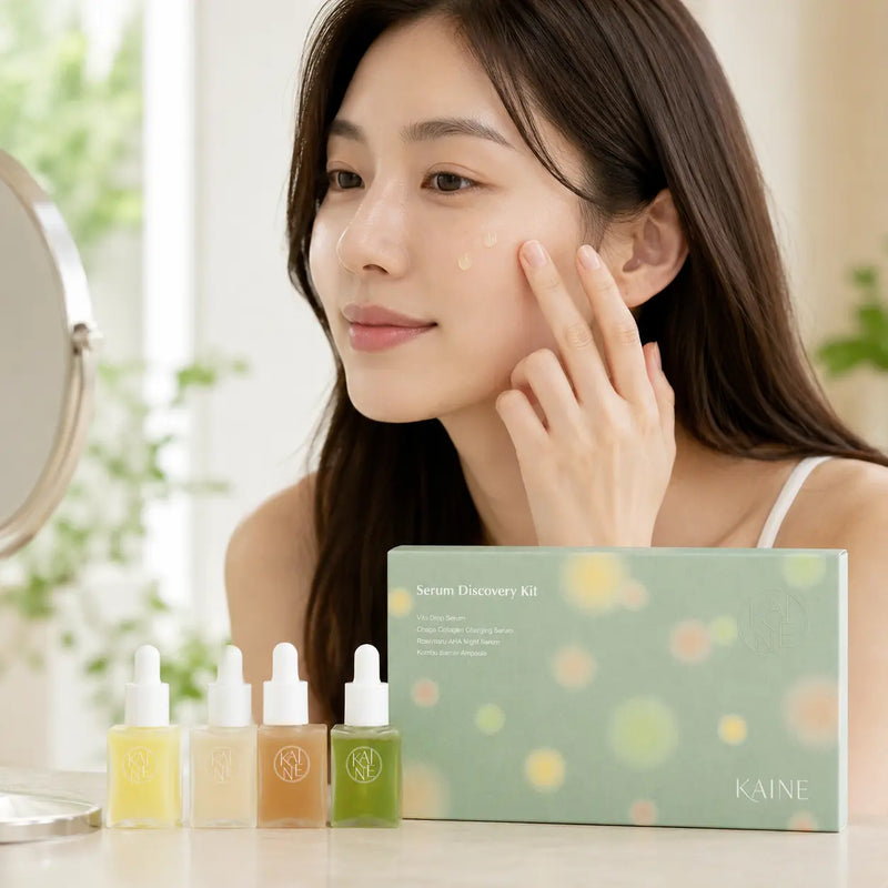 Woman applying KAINE Vita Drop Serum with the discovery set