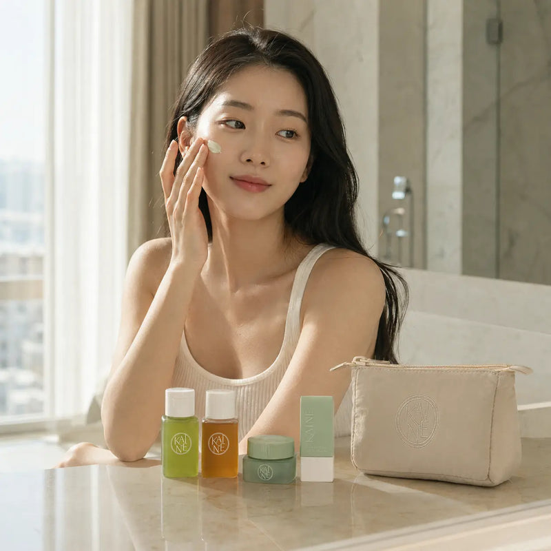 Woman applying KAINE Green Calm Aqua Cream with the travel kit