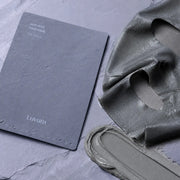 Luvum Pore Reset Mud Mask woven sheet and gray clay texture