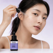 Applying clear MEDIHEAL PDRN Lifting Serum drops to the cheek