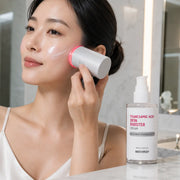 Woman using MEDITHERAPY booster device over Tranexamic Acid cream
