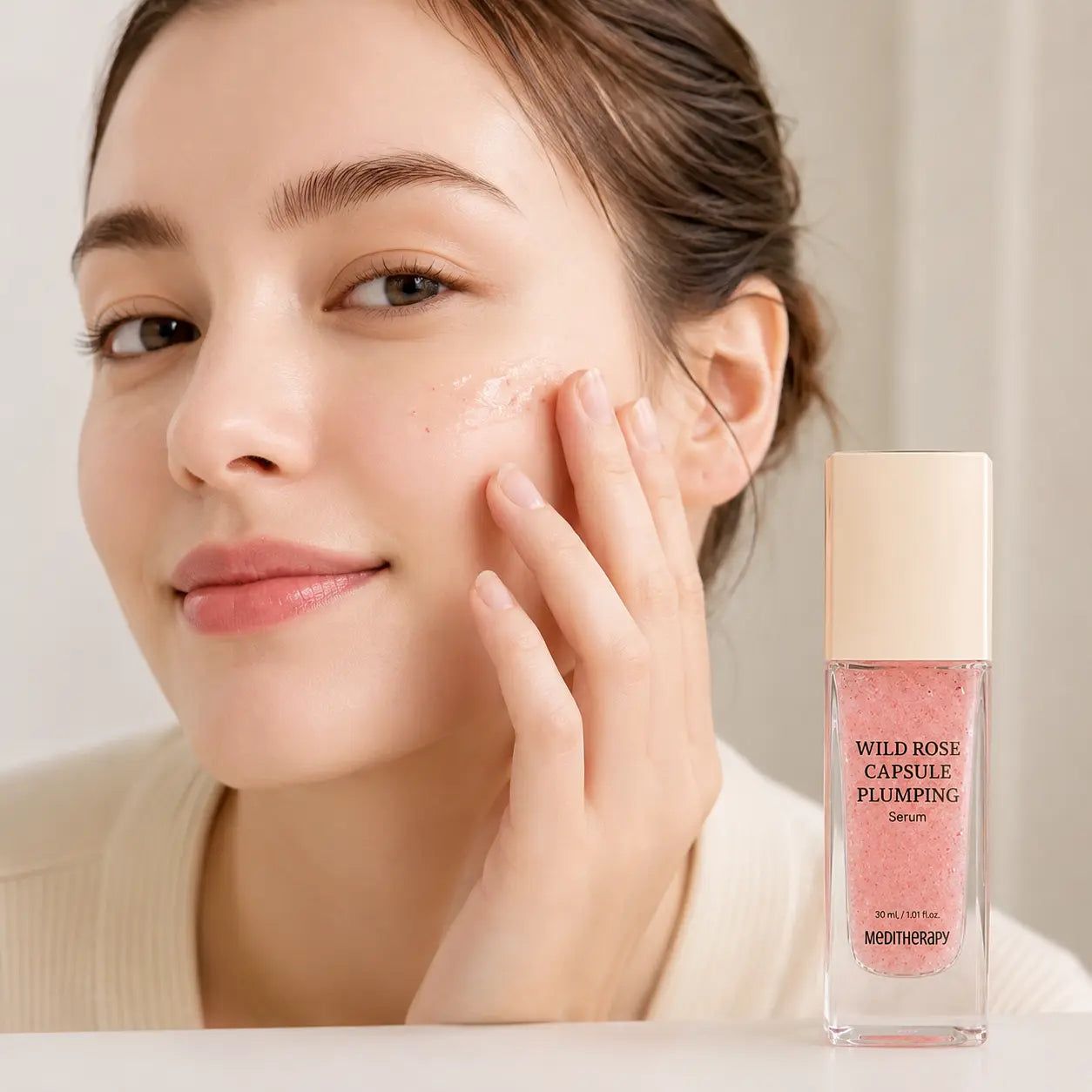 Applying MEDITHERAPY Wild Rose Capsule Plumping Serum to the cheek