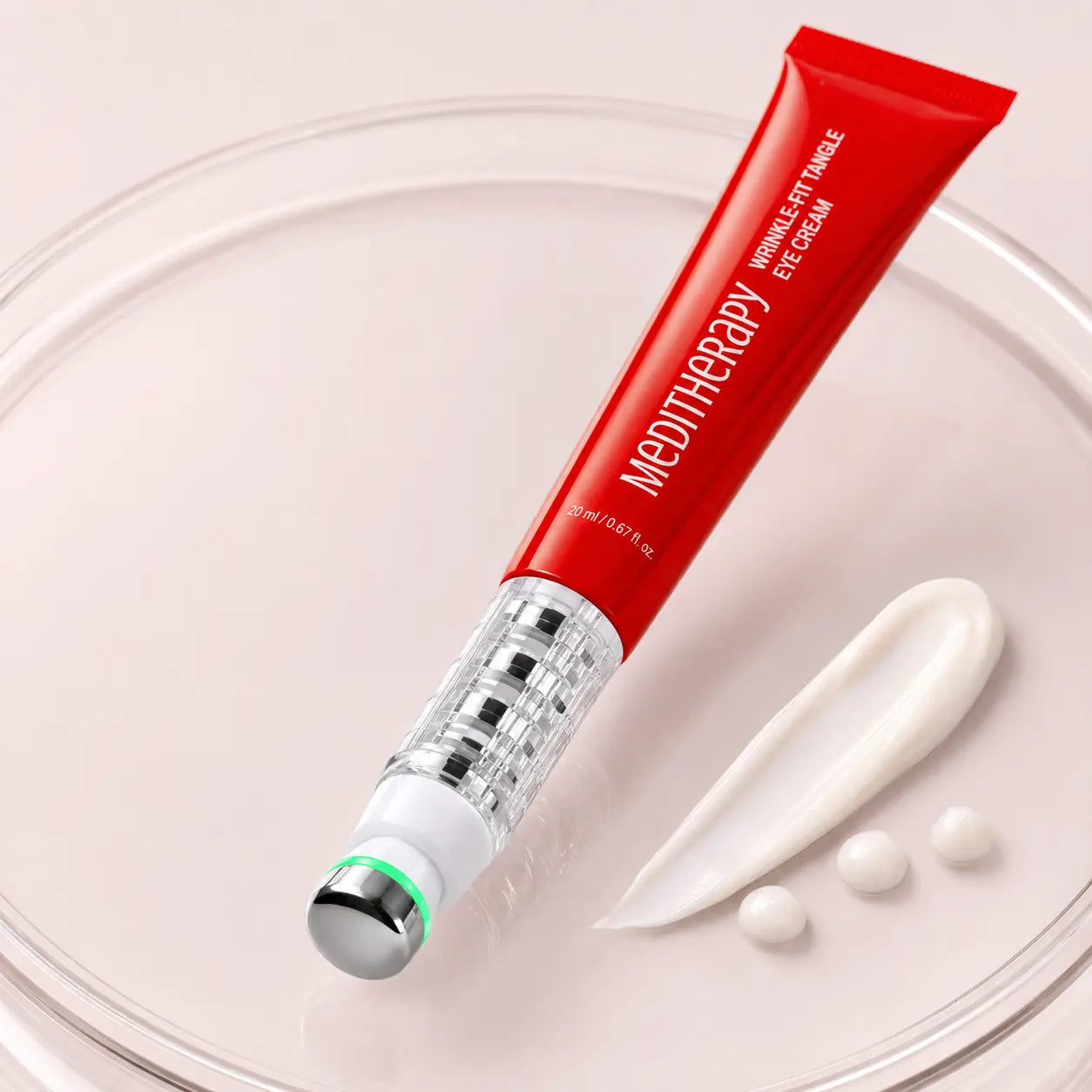 Macro view of MEDITHERAPY eye massage tip and cushioned ivory eye cream texture