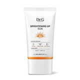 ProtoClinical k-beauty Dr.G Brightening Up Sun SPF50+ PA+++ 50ml single upright pale beige sunscreen tube centered on a light background with soft peach side accents