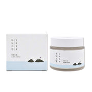 ProtoClinical k-beauty ROUND LAB 1025 DOKDO Cream 80mL abstract beauty graphic with pale blue, gray, and peach tones on a light background.