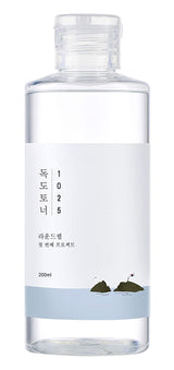 ProtoClinical k-beauty Round Lab 1025 Dokdo Toner 200ml abstract product graphic with an upright pale blue column, rounded gray blocks, and a white background
