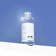 ProtoClinical k-beauty Round Lab 1025 Dokdo Toner 200ml deep blue product silhouette with a bright center on a white background.