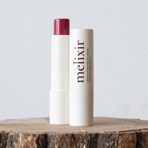 ProtoClinical k-beauty melixir Vegan Lip Butter 3.9g #05 Dewy Rose (Tinted) open rosy lip butter stick beside a capped white tube on a cut wood surface against a pale gray background