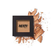 ProtoClinical k-beauty MERZY THE FIRST EYESHADOW 2g (5 Colors) single square black compact with a metallic gold shadow pan, set over scattered crushed powder on a white background