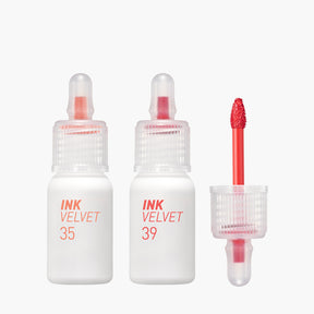 ProtoClinical k-beauty peripera Ink Airy Velvet 4g (NEW #35~#39) two upright lip tint package silhouettes with a slim peach tube beside a taller brown rectangular box on a pale blue and white background