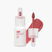ProtoClinical k-beauty peripera Ink Airy Velvet 4g (NEW #35~#39) two upright lip tint package silhouettes with a slim peach tube beside a taller brown rectangular box on a pale blue and white background