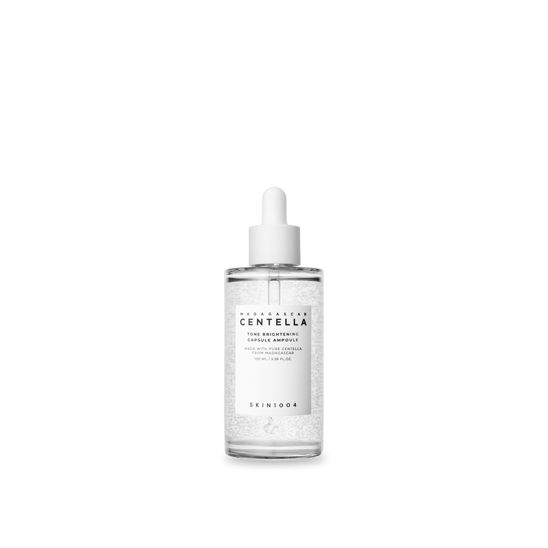 ProtoClinical k-beauty SKIN1004 TONE BRIGHTENING CAPSULE AMPOULE 100ml in an upright clear dropper bottle with a white cap, centered white label, and visible micro-capsules