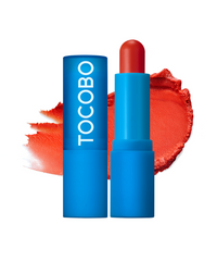 ProtoClinical k-beauty TOCOBO Powder Cream Lip Balm 3.5g #033 Carrot Cake single blue lip balm tube standing vertically on a pale background with pink side accents