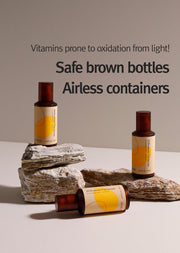 ProtoClinical k-beauty 12GRABS: 10 Elements Vita Serum (50ml) three amber serum bottles arranged on layered rocks with bold black headline text on a beige background