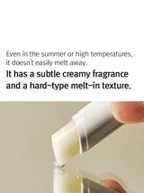 ProtoClinical k-beauty 12GRABS Vegan Lip Balm 4g close-up of a white balm stick held between fingers above a reflective beige surface with black headline text