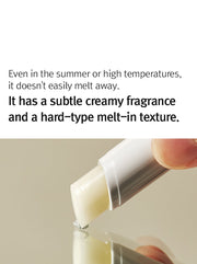 ProtoClinical k-beauty 12GRABS Vegan Lip Balm 4g close-up of a white balm stick held between fingers above a reflective beige surface with black headline text