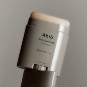 ProtoClinical k-beauty dark vertical beauty product on a light background.