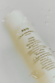 ProtoClinical k-beauty taupe vertical beauty graphic on a soft gray background.
