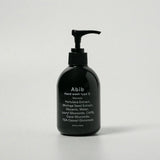 ProtoClinical k-beauty dark vertical beauty product with pale beige side highlights on a white background.