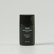 ProtoClinical k-beauty Abib Heartleaf sun essence Calming drop 50ml (SPF50+ PA++++) single upright dark sun essence package centered on a light background.