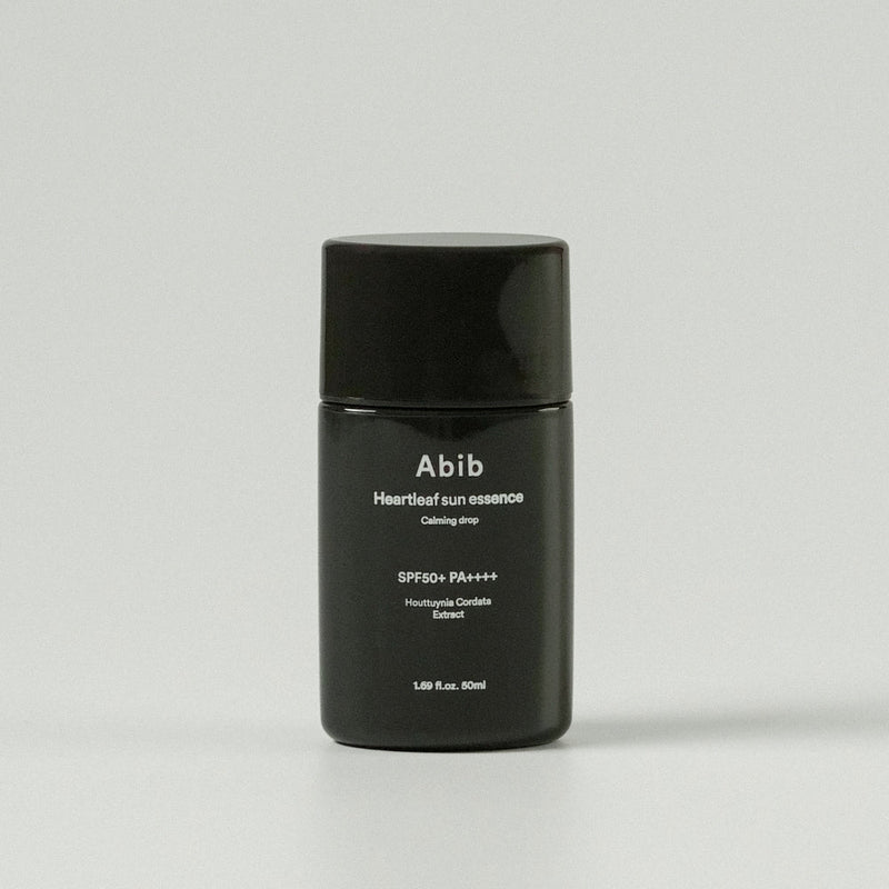 ProtoClinical k-beauty Abib Heartleaf sun essence Calming drop 50ml (SPF50+ PA++++) single upright dark sun essence package centered on a light background.