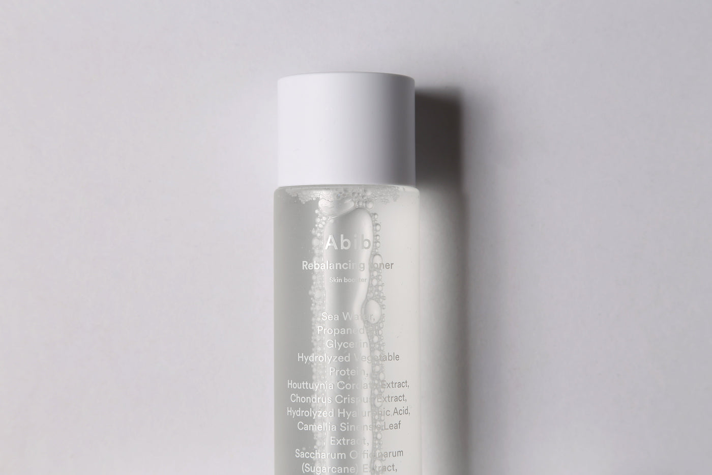 ProtoClinical k-beauty gray beauty graphic with a darker vertical center on a light background.