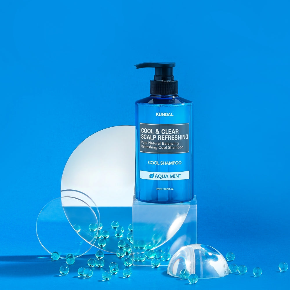 ProtoClinical k-beauty KUNDAL COOL&CLEAR SCALP REFRESHING Pure Natural Balancing Refreshing Cool Shampoo 500ml #AQUA MINT single upright deep blue shampoo bottle centered on a light blue background.