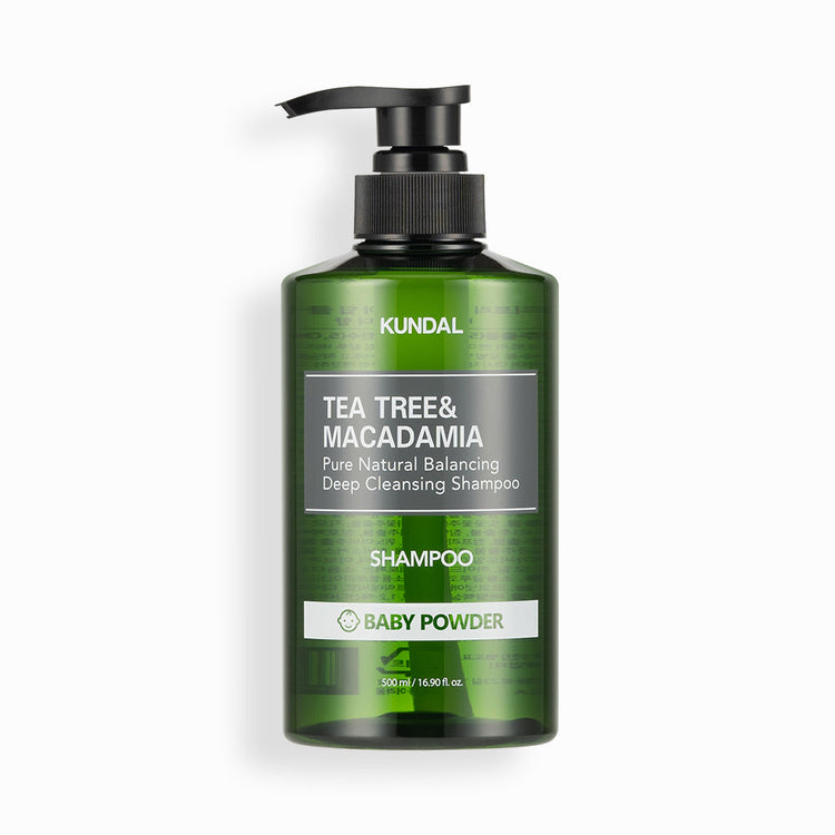 ProtoClinical k-beauty KUNDAL TEA TREE&MACADAMIA Pure Natural Balancing Deep Cleansing Shampoo 500ml #BABY POWDER single dark green shampoo bottle centered on a white background with pale pink side accents.