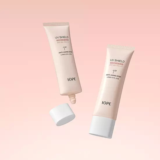 ProtoClinical k-beauty IOPE UV Shield Essential Tone-up Sun SPF 50+ PA++++ 50ml light beige skincare product on a pale pink gradient background