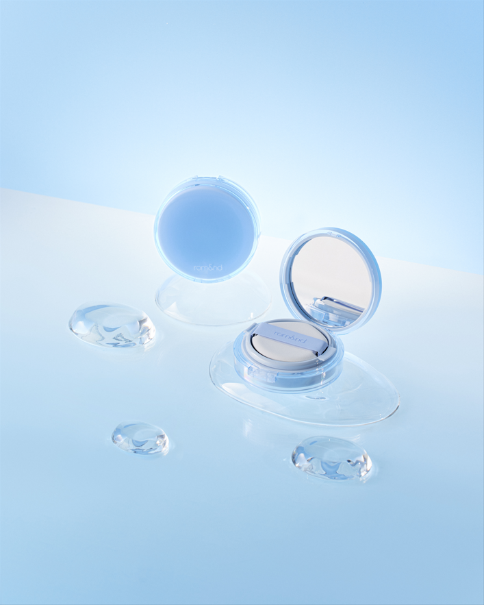 ProtoClinical k-beauty rom&nd Bare Water Cushion 5 Shades single cushion compact lying flat with a beige center on a pale blue and white background