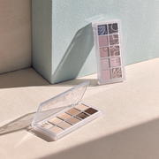 ProtoClinical k-beauty taupe beauty product silhouette with a soft gray center on a pale beige background.