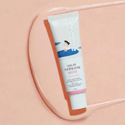 ProtoClinical k-beauty Round Lab Birch Juice Moisturizing Tone Up Sunscreen 50ml (SPF 50+ PA++++) single white sunscreen tube laid diagonally on a peach tray with a pink cap band
