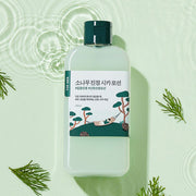 ProtoClinical k-beauty abstract beauty graphic with a muted teal center and soft green accents on a pale yellow background.