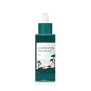 ProtoClinical k-beauty beauty product silhouette with a dark gray vertical center on a white background with soft peach side accents.
