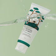 ProtoClinical k-beauty Round Lab Pine Calming Cica Cleanser 150ml single white cleanser tube tilted under a clear water splash on a pale green background