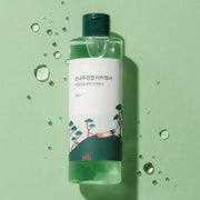 ProtoClinical k-beauty Round Lab Pine Calming Cica Toner 250ml graphic with mint and teal tones and green right-side accents.