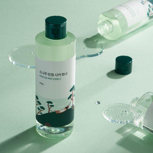 ProtoClinical k-beauty Round Lab Pine Calming Cica Toner 250ml graphic with soft mint tones and deeper teal lower accents.