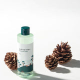 ProtoClinical k-beauty Round Lab Pine Calming Cica Toner 250ml product graphic with two slim bottle silhouettes, a vivid blue center band, and a pale background