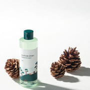 ProtoClinical k-beauty Round Lab Pine Calming Cica Toner 250ml product graphic with two slim bottle silhouettes, a vivid blue center band, and a pale background