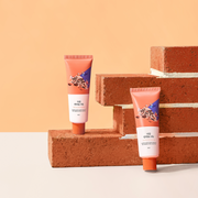 ProtoClinical k-beauty warm peach beauty graphic with a dark brown lower accent on a light background.