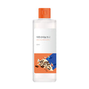 ProtoClinical k-beauty Round Lab Soybean Panthenol Toner 250ml single upright amber toner bottle on a warm beige background with a white base.