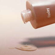 ProtoClinical k-beauty Huxley Conditioning Essence Toner Freeshape 300ml shown as a brown packaging graphic on a light peach background