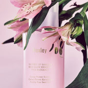ProtoClinical k-beauty Huxley Skin Glow Essence Vita Radiance 50ml with soft rose, charcoal, and cream packaging forms on a pale background