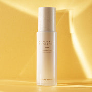 ProtoClinical k-beauty warm yellow beauty product detail with soft peach and beige tones on a light background.