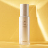ProtoClinical k-beauty warm yellow beauty product detail with soft peach and beige tones on a light background.