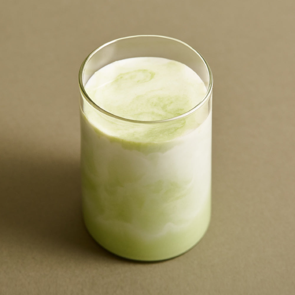 ProtoClinical k-beauty OSULLOC Organic Premium Matcha Powder 40g packaging with a cream vertical panel and dark olive tones on a warm background.