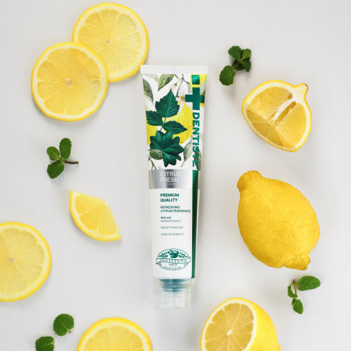 ProtoClinical k-beauty DENTISTE Citrus Fresh Toothpaste 100g single upright blue-green toothpaste package centered on a light background with soft peach side accents.
