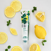 ProtoClinical k-beauty DENTISTE Citrus Fresh Toothpaste 100g single upright blue-green toothpaste package centered on a light background with soft peach side accents.