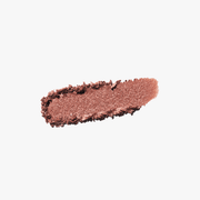 ProtoClinical k-beauty warm copper and beige beauty close-up with a centered darker vertical form on a pale blue and white background.