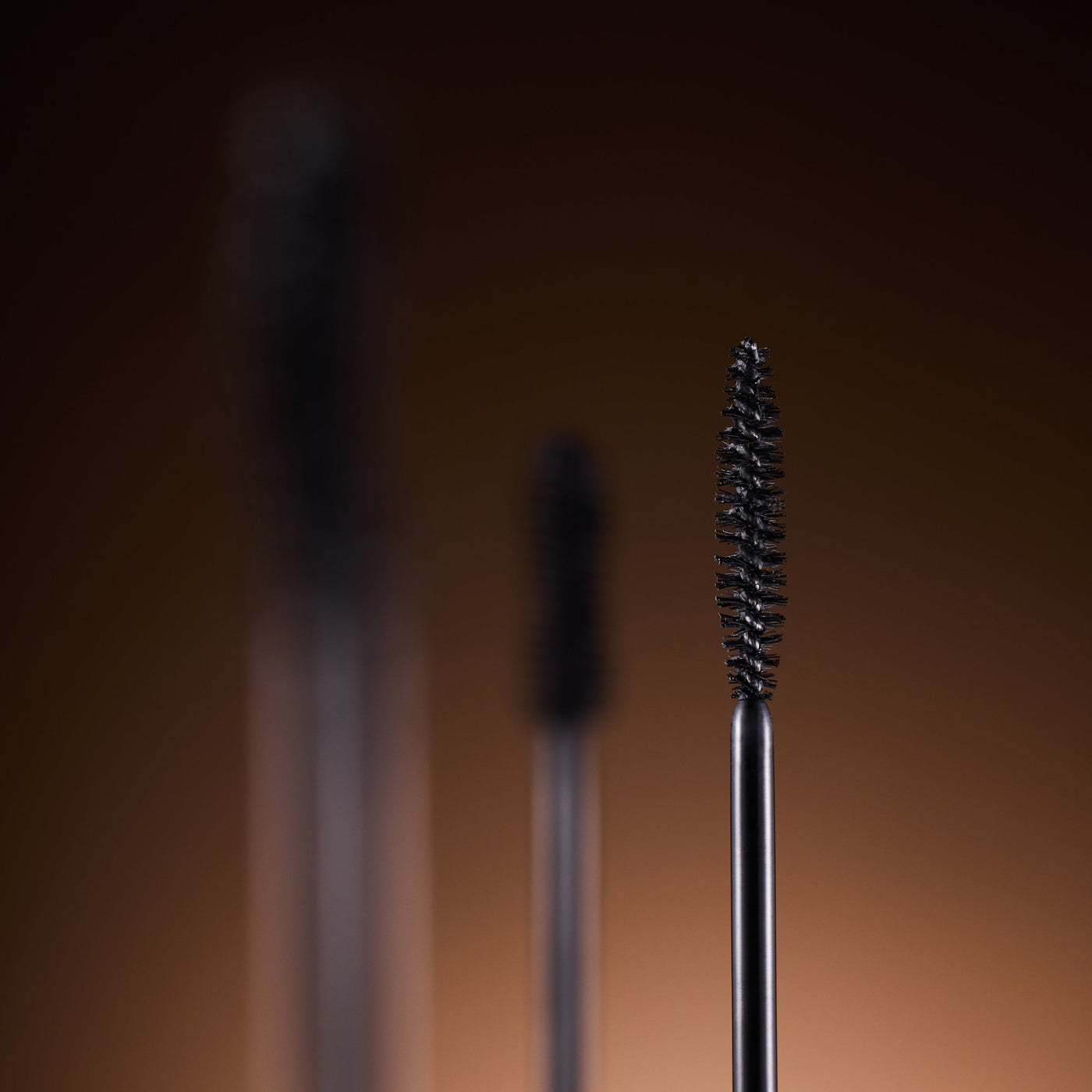 DEAR DAHLIA Paradise Dream Lash Defining Mascara by ProtoClinical shown in k-beauty mascara packaging with a warm beige center on a deep brown background.